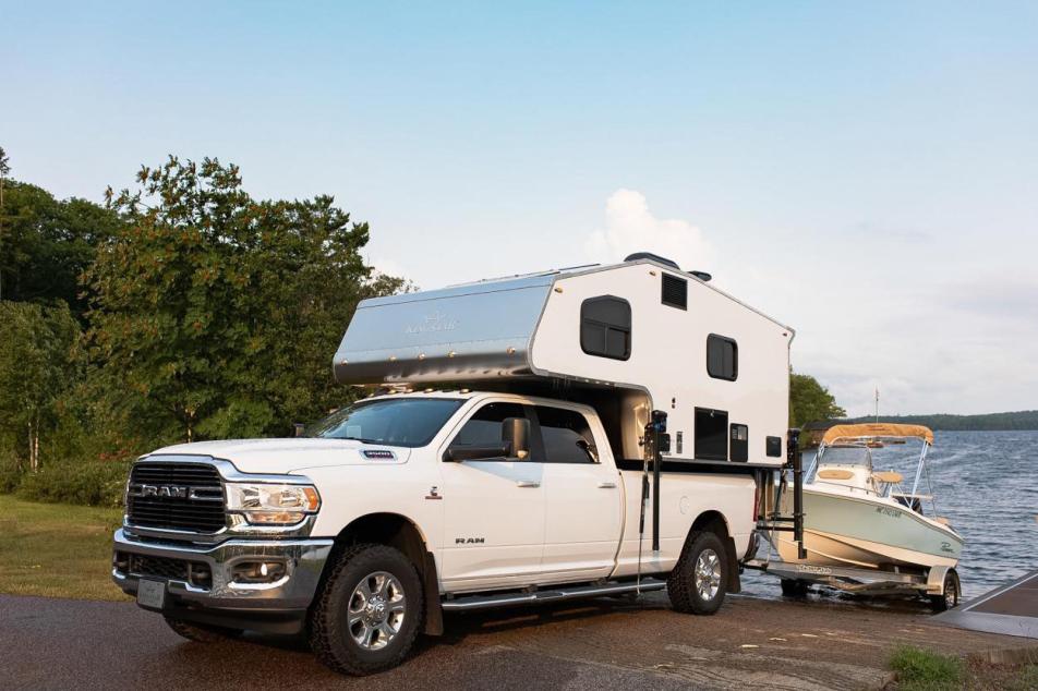 Kingstar Truck Bed Camper backing into the water with boat 